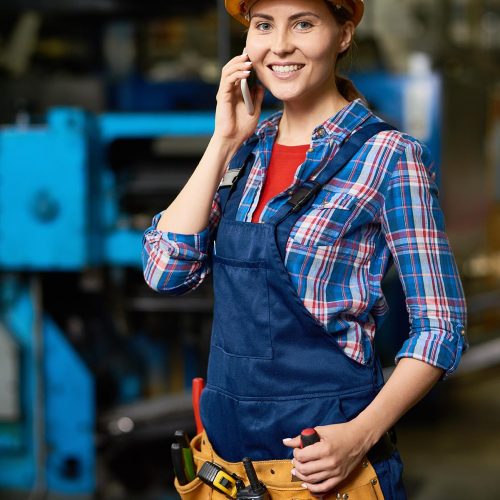 young-woman-speaking-by-phone-in-modern-factory-KN6RE3T.jpg